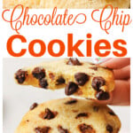 A stack of chocolate chip cookies and a hand lifting the top cookie which is broken in half.