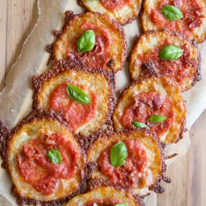 Pizza bites arranged on parchment paper.