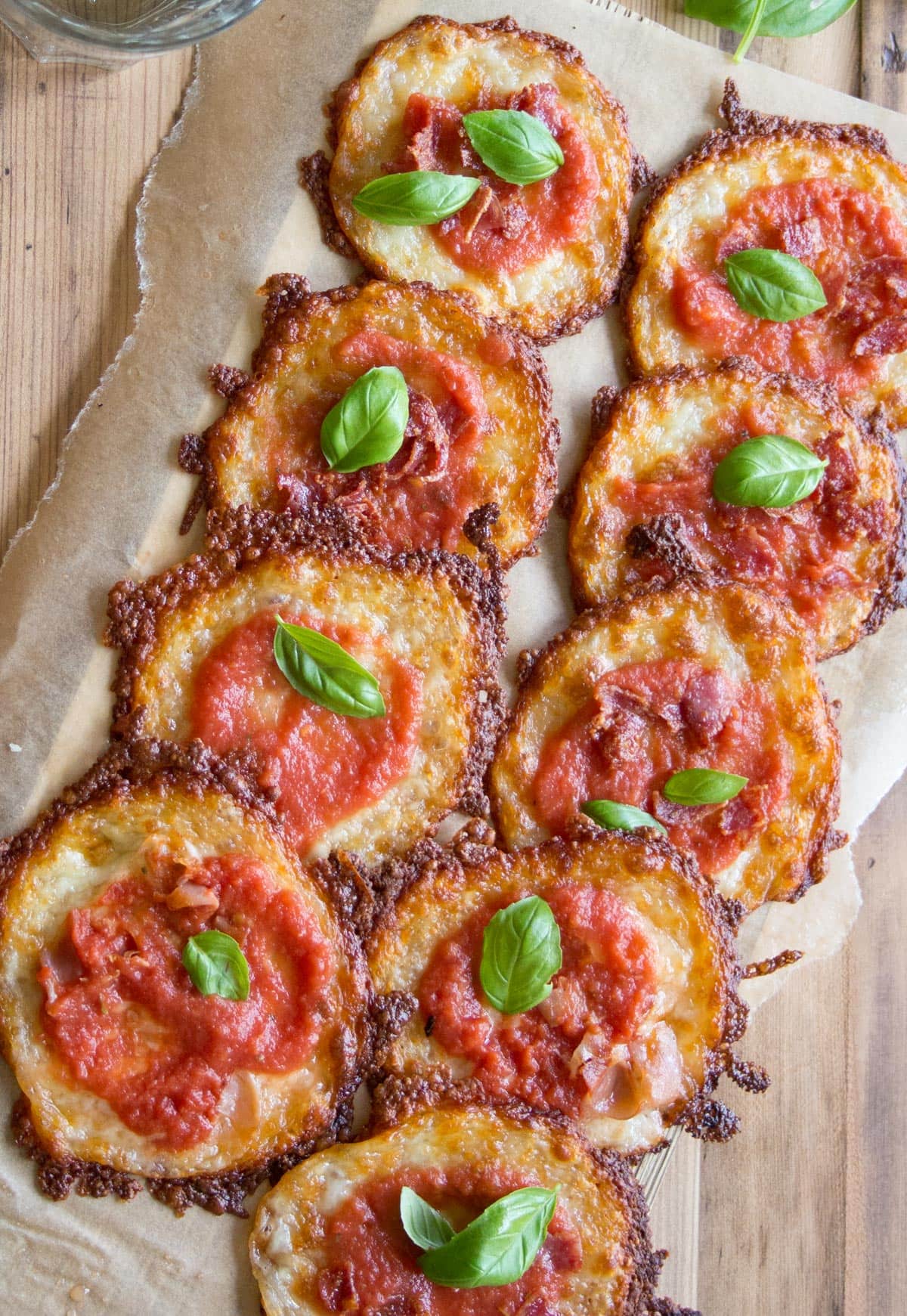 Pizza bites on a tray lined with parchment paper.