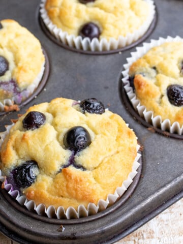 Blueberry muffins in a muffin pan.