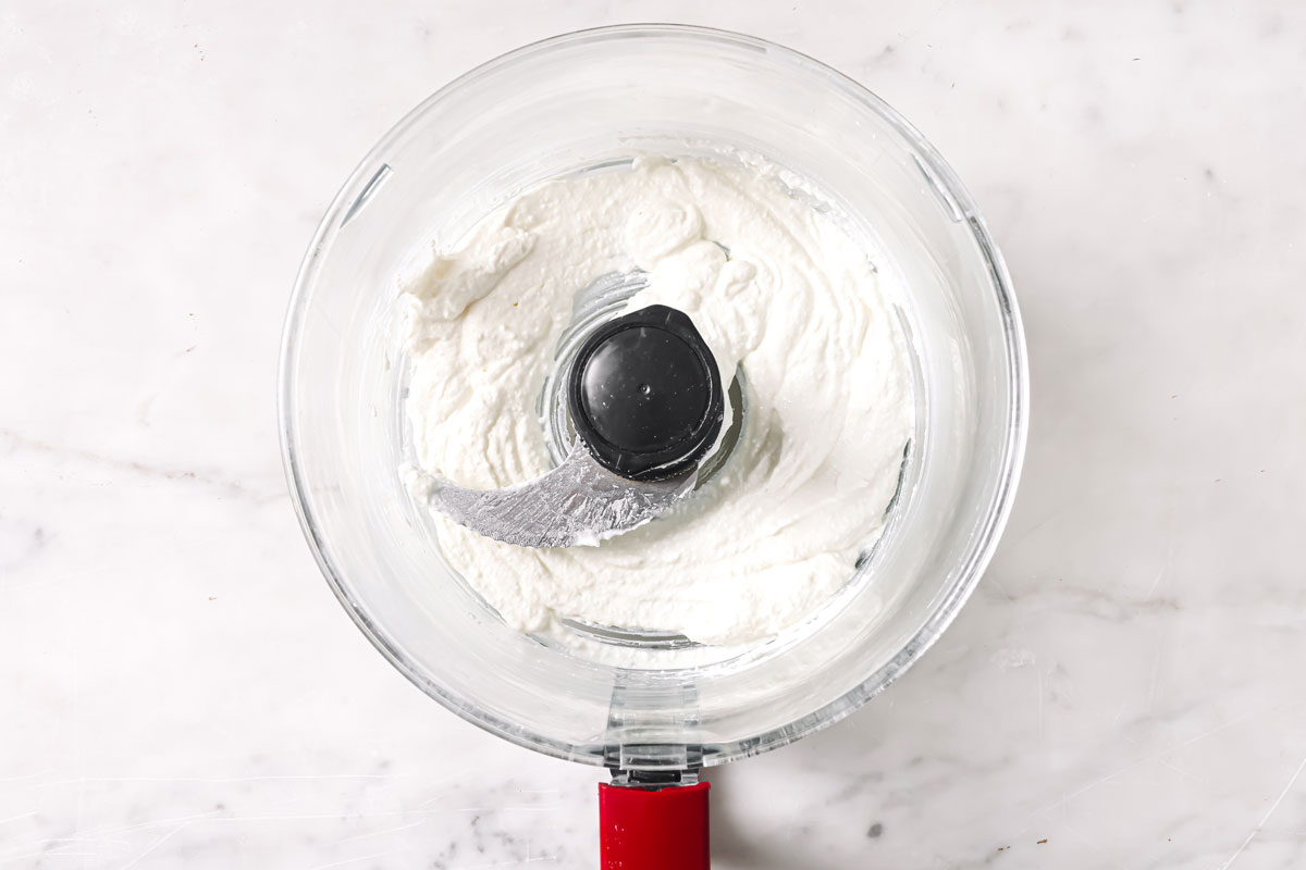 Whipped cottage cheese in a food processor bowl.