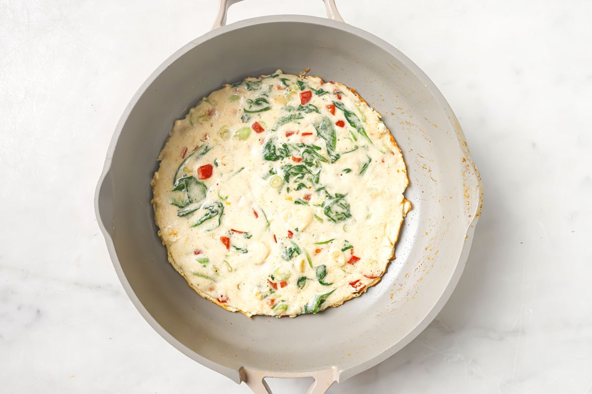 Set egg white omelette in a pan.