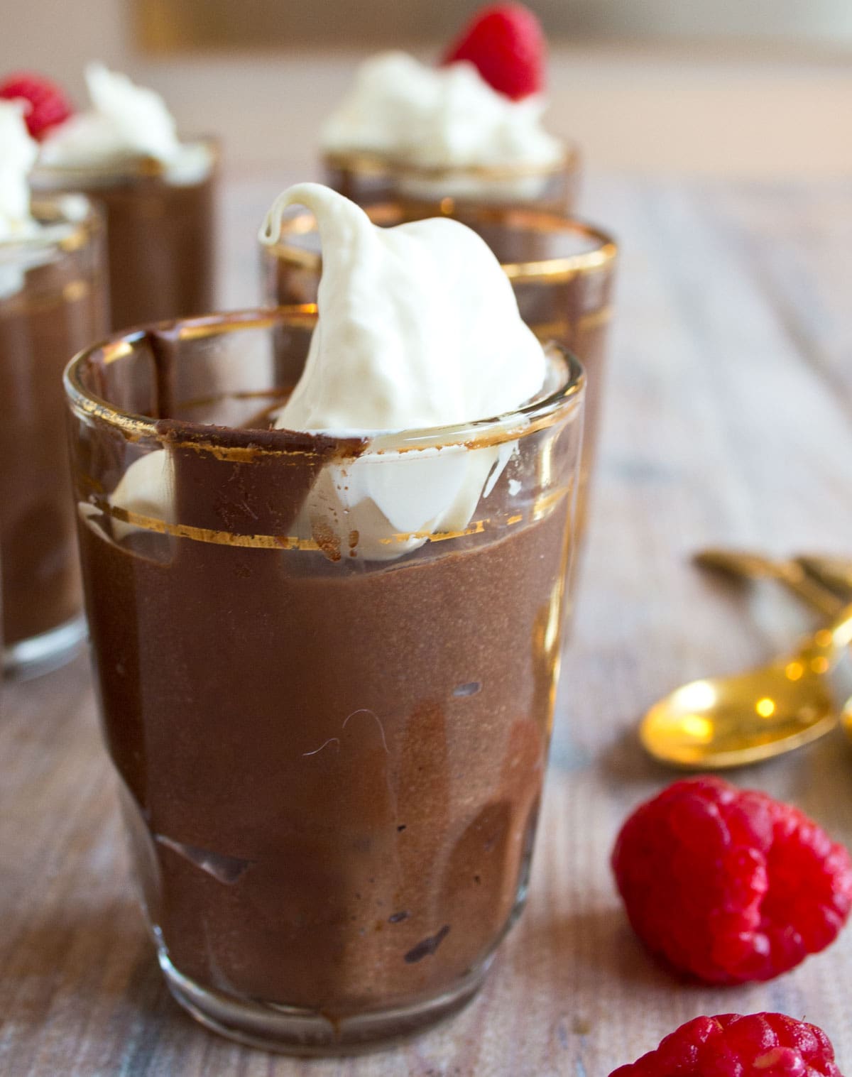 A glass cup with sugar free chocolate mousse, topped with whipped cream.