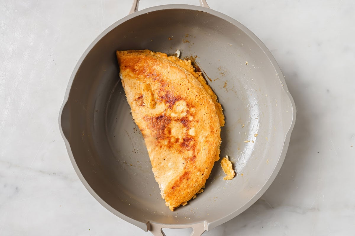 Folded omelette in a pan.