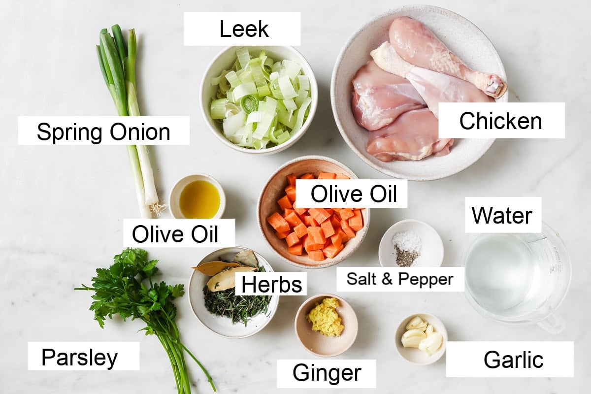 Ingredients to make this chicken soup recipe, measured into bowls and labelled.