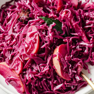 Braised red cabbage with apple slices in a bowl.