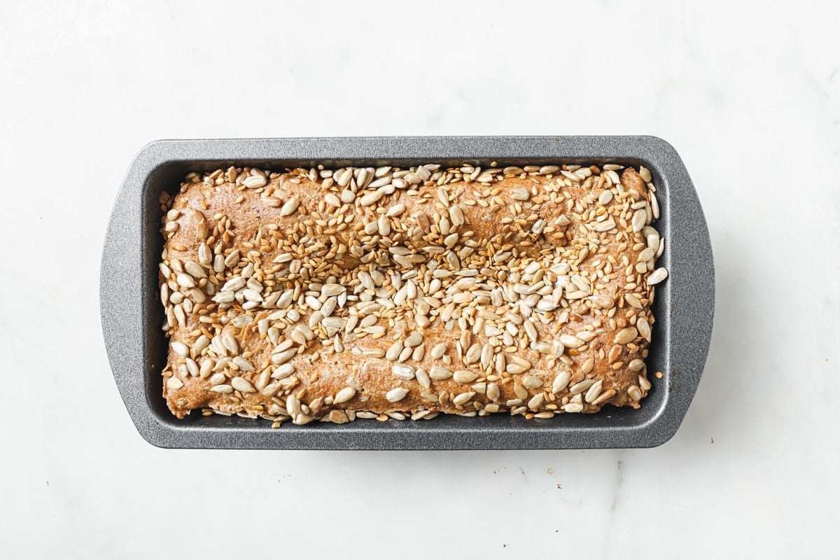 Baked bread in a rectangular loaf pan.