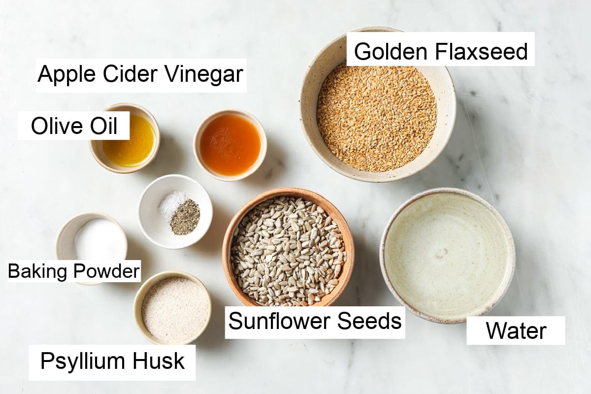 Ingredients to make flaxseed bread, measured into bowls and labelled.