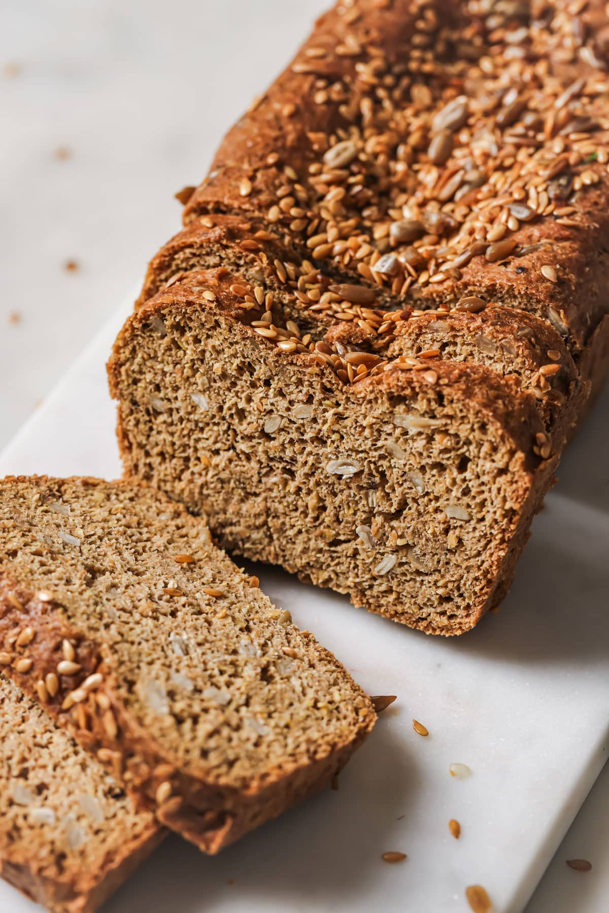 A loaf of flaxseed bread, slicced.