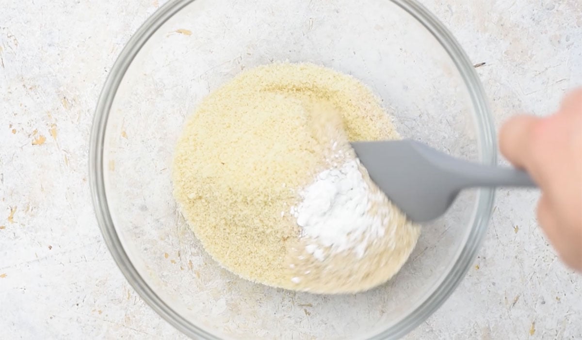Combining dry ingredients with a spatula.