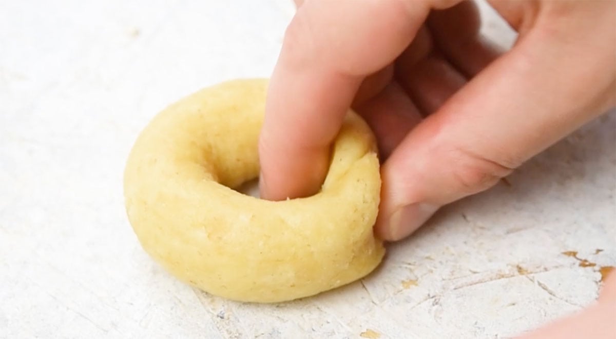 Forming bagels with hands.