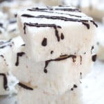 Stacked keto coconut bars with chocolate drizzle.