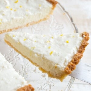 A slice of low carb lemon cheesecake topped with lemon zest.