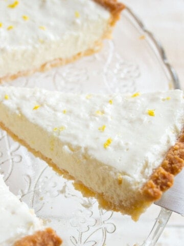 A slice of low carb lemon cheesecake topped with lemon zest.
