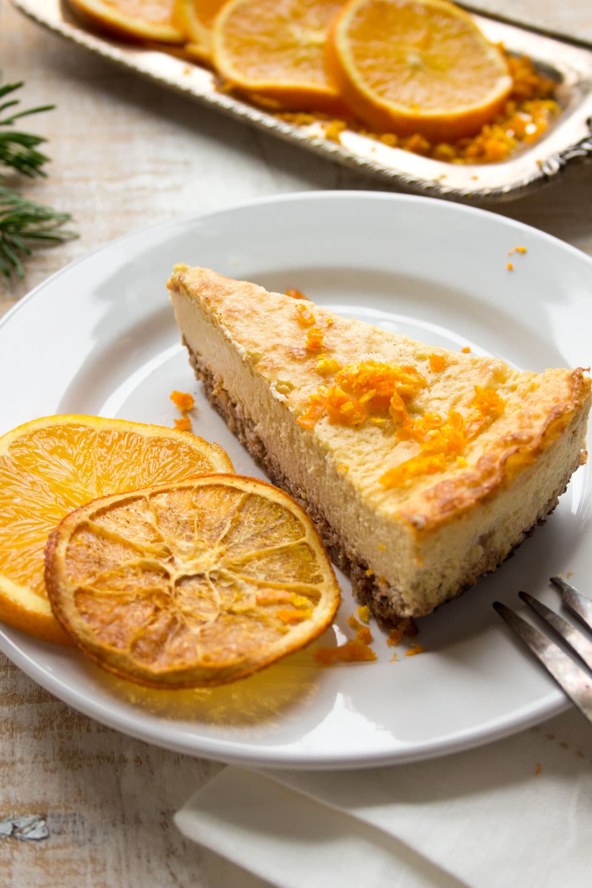 A slice of orange cheesecake on a plate.