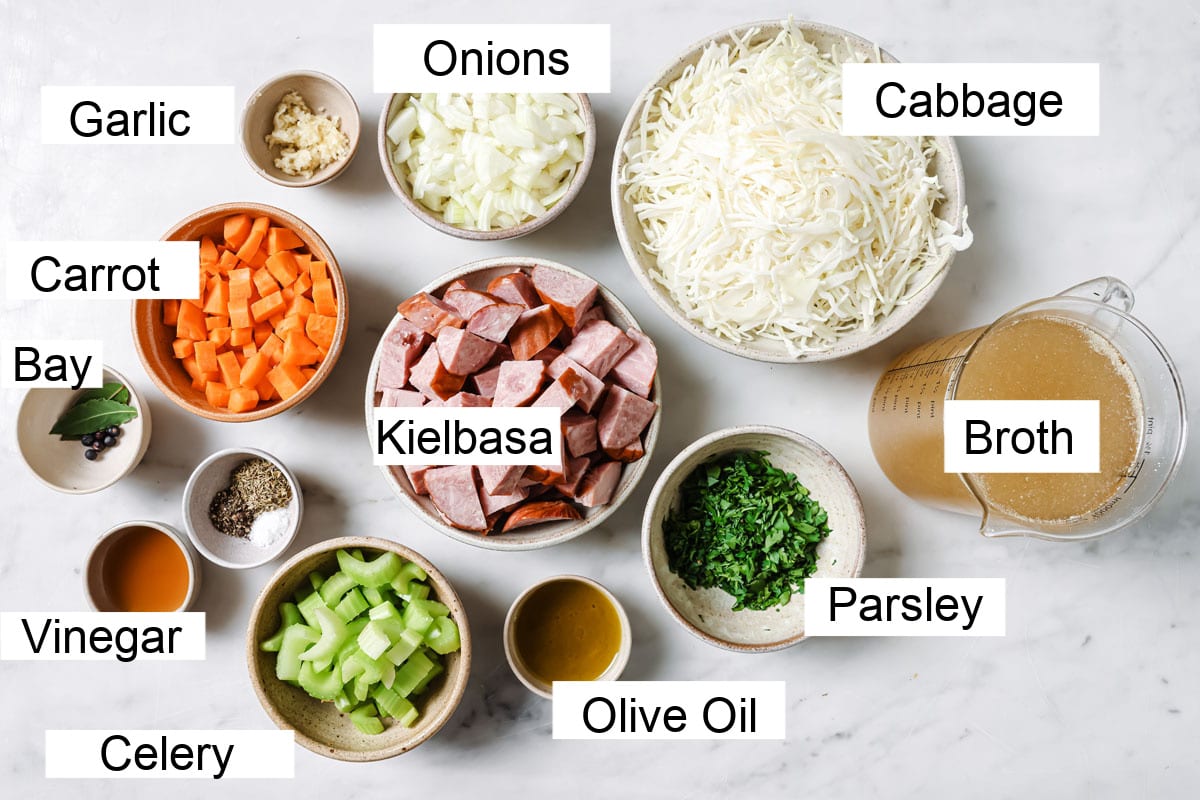 Ingredients to make keto cabbage soup, measured into bowls and labelled.