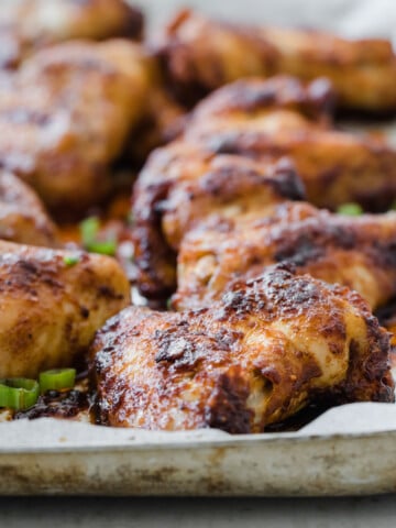 Oven-baked crispy chicken wings on a baking pan.