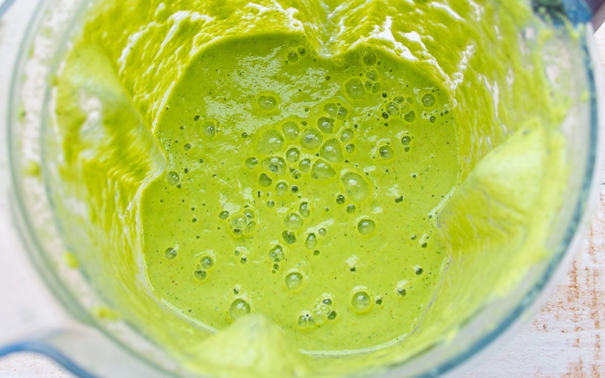 Green smoothie in a blender jug.