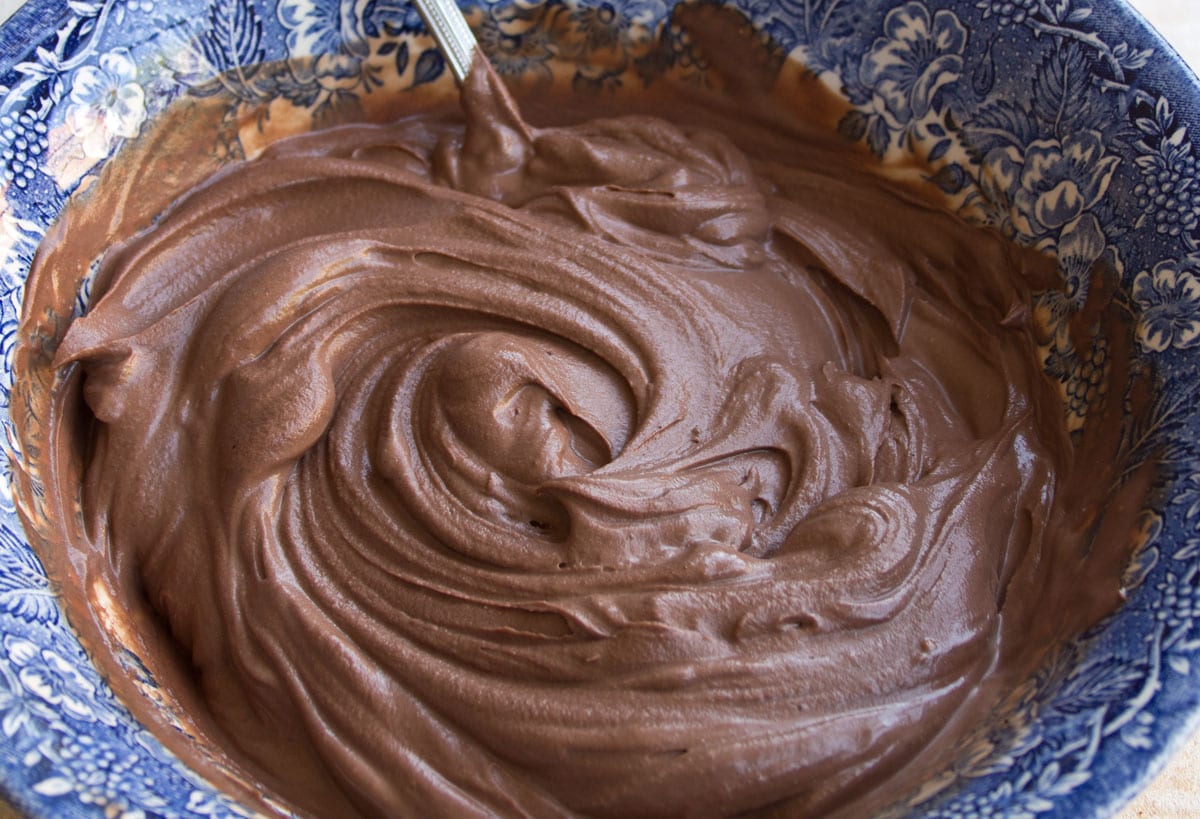 Stirring the chocolate mascarpone mousse in a bowl with a spoon.