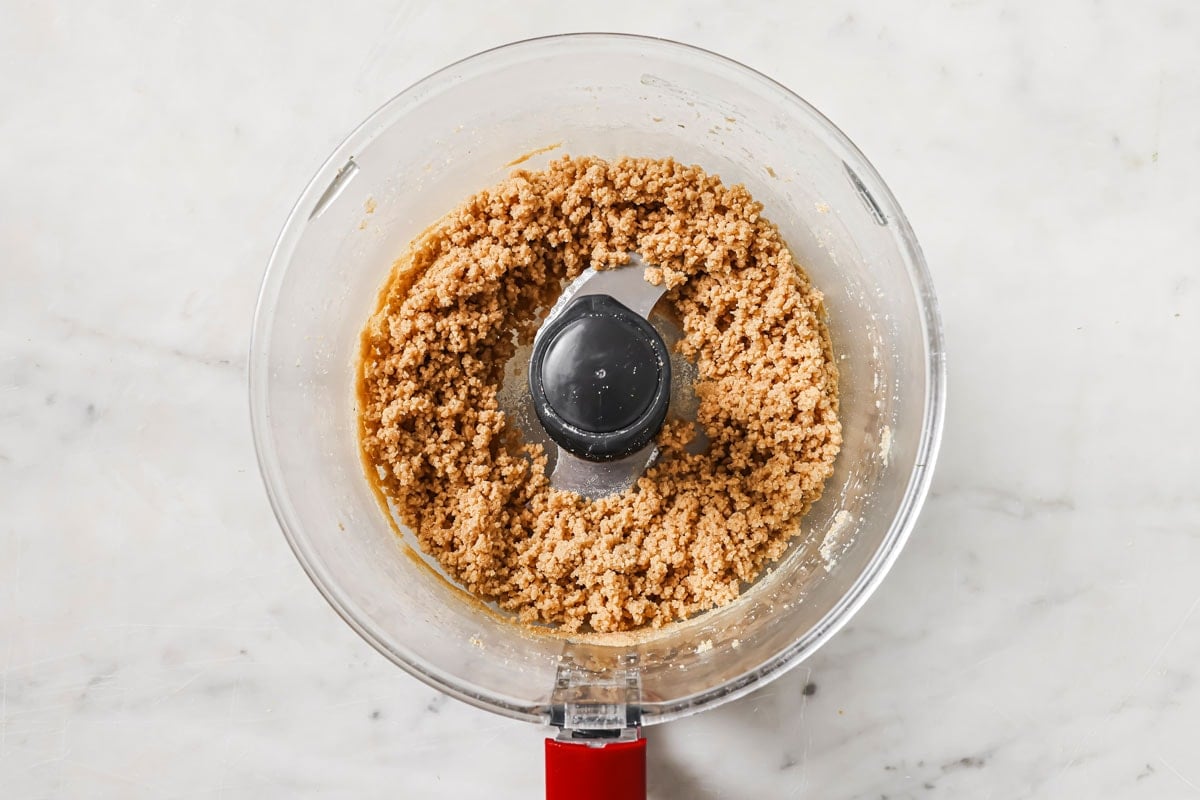 Crumbly cookie dough in a food processor.