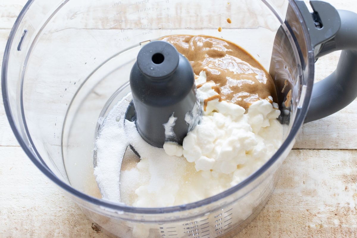 Cottage cheese, peanut butter, sweetener and vanilla extract in a food processor bowl.