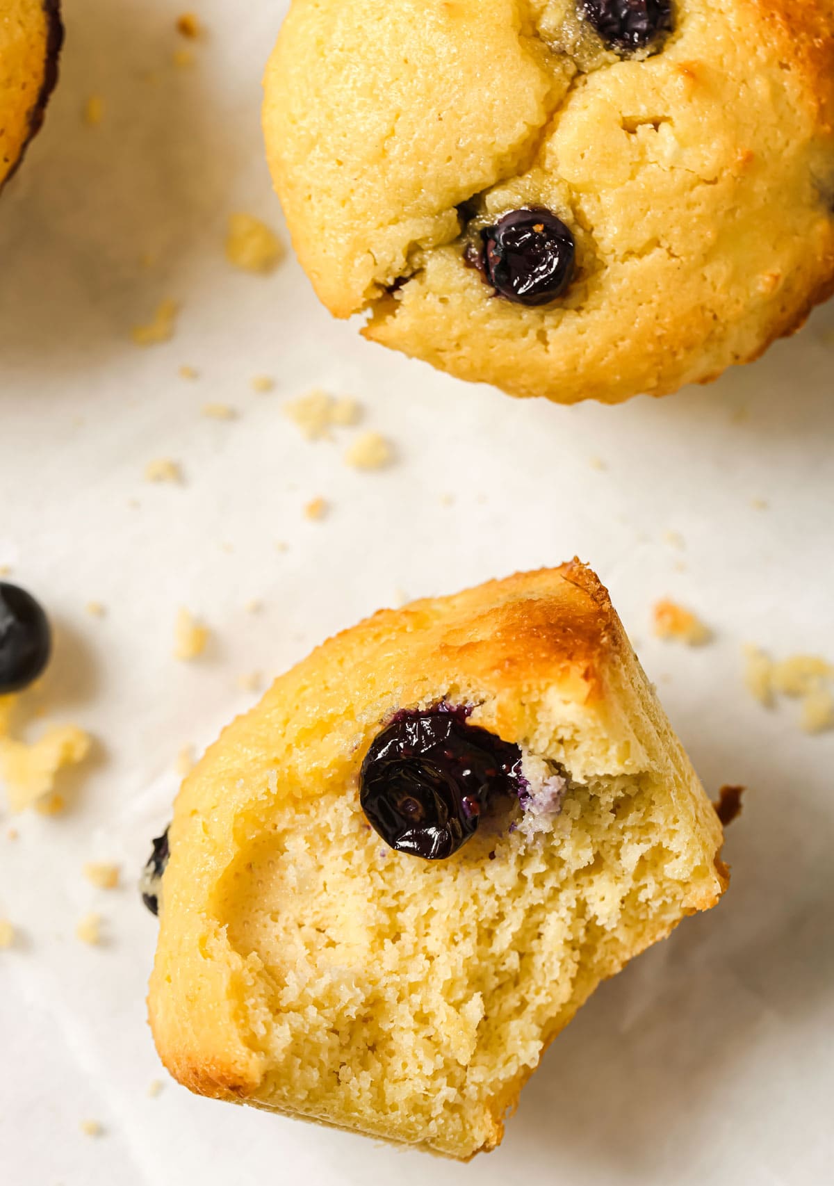 Half a muffin and a white surface.