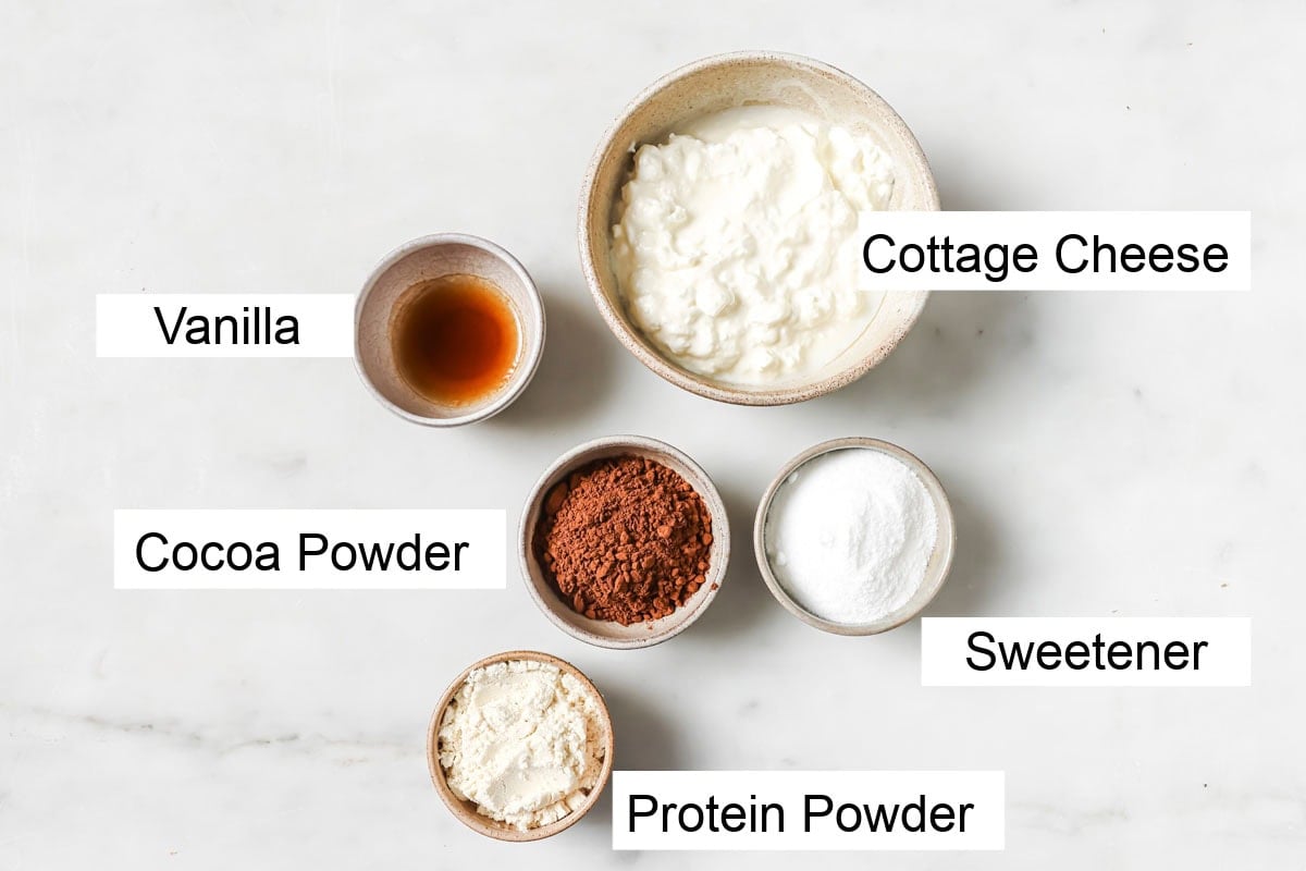 Ingredients to make chocolate protein pudding, measured into bowls and labelled.