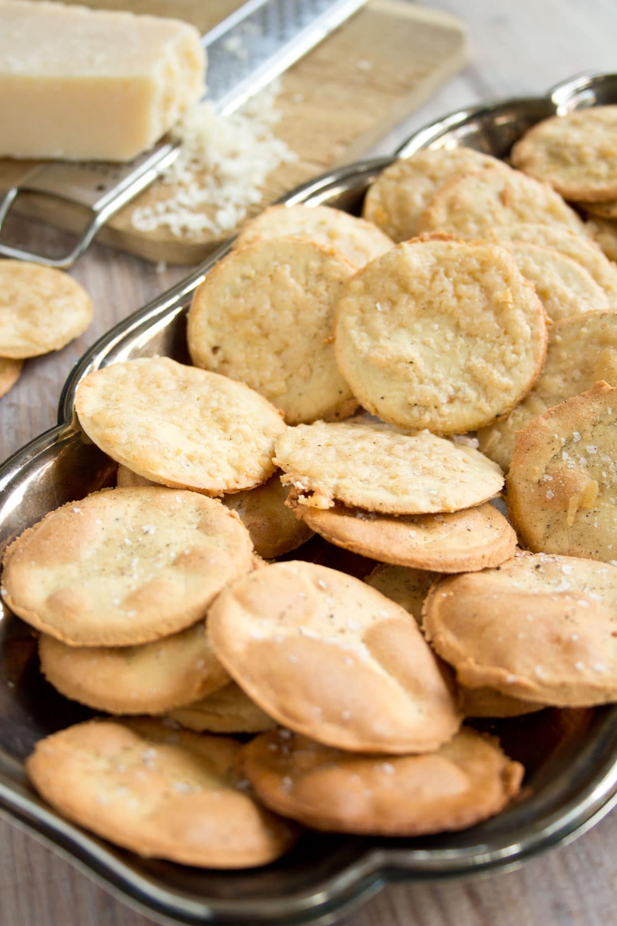 Round almond flour crackers in a silver tray.