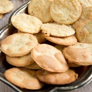 Round almond flour crackers on a silver tray.