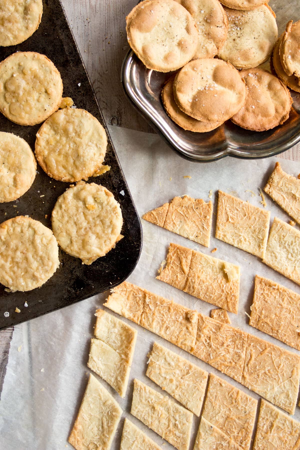 3 different types of Almond flour crackers - round with pepper and salt, round topped with cheese and cut into diamond shapes.