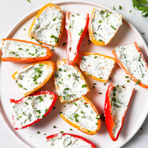 Cream cheese stuffed mini peppers on a plate.