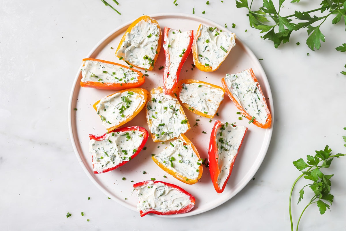 Cream cheese mixture in halved peppers.