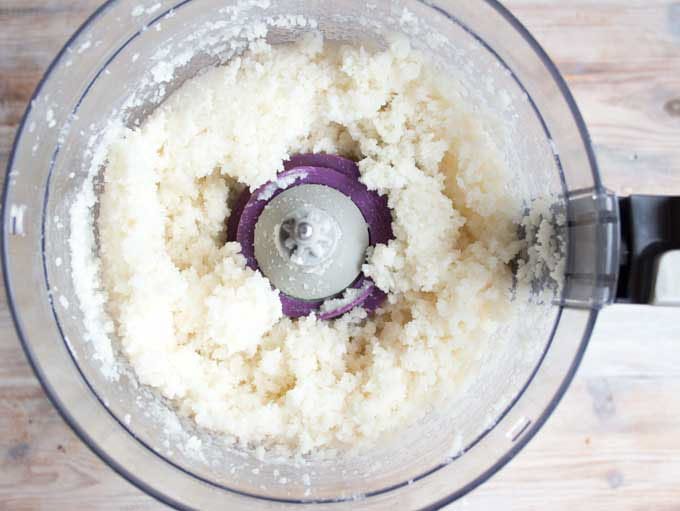 Coconut filling in a food processor bowl.