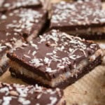 A keto bounty bar square topped with desiccated coconut.