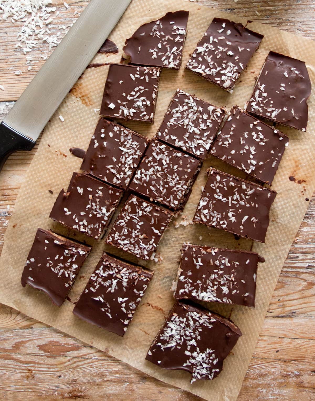 Sugar free bounty bar squares with a knife.