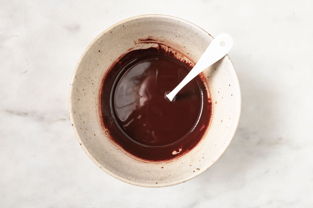 Melted chocolate in a bowl with a spoon.