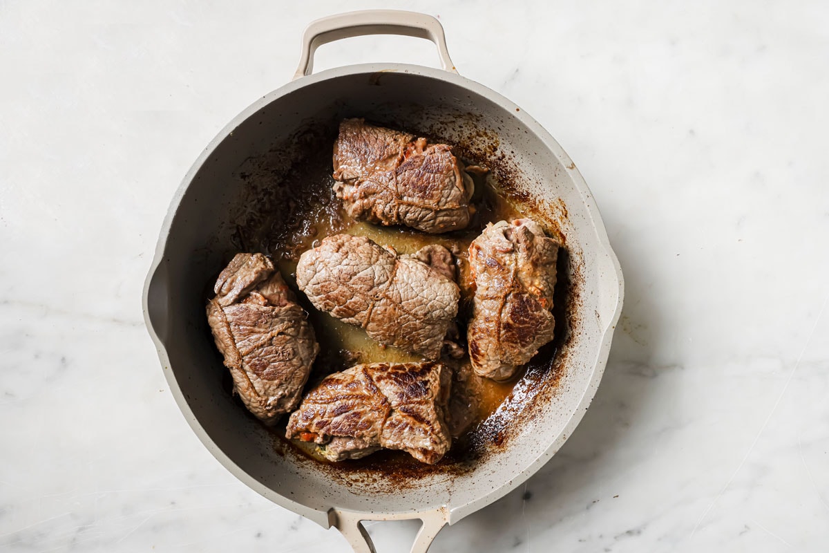 Browning the rouladen in a pan.