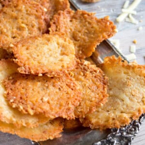 Keto cheese chips made with cheddar and pork rinds on a silver tray.