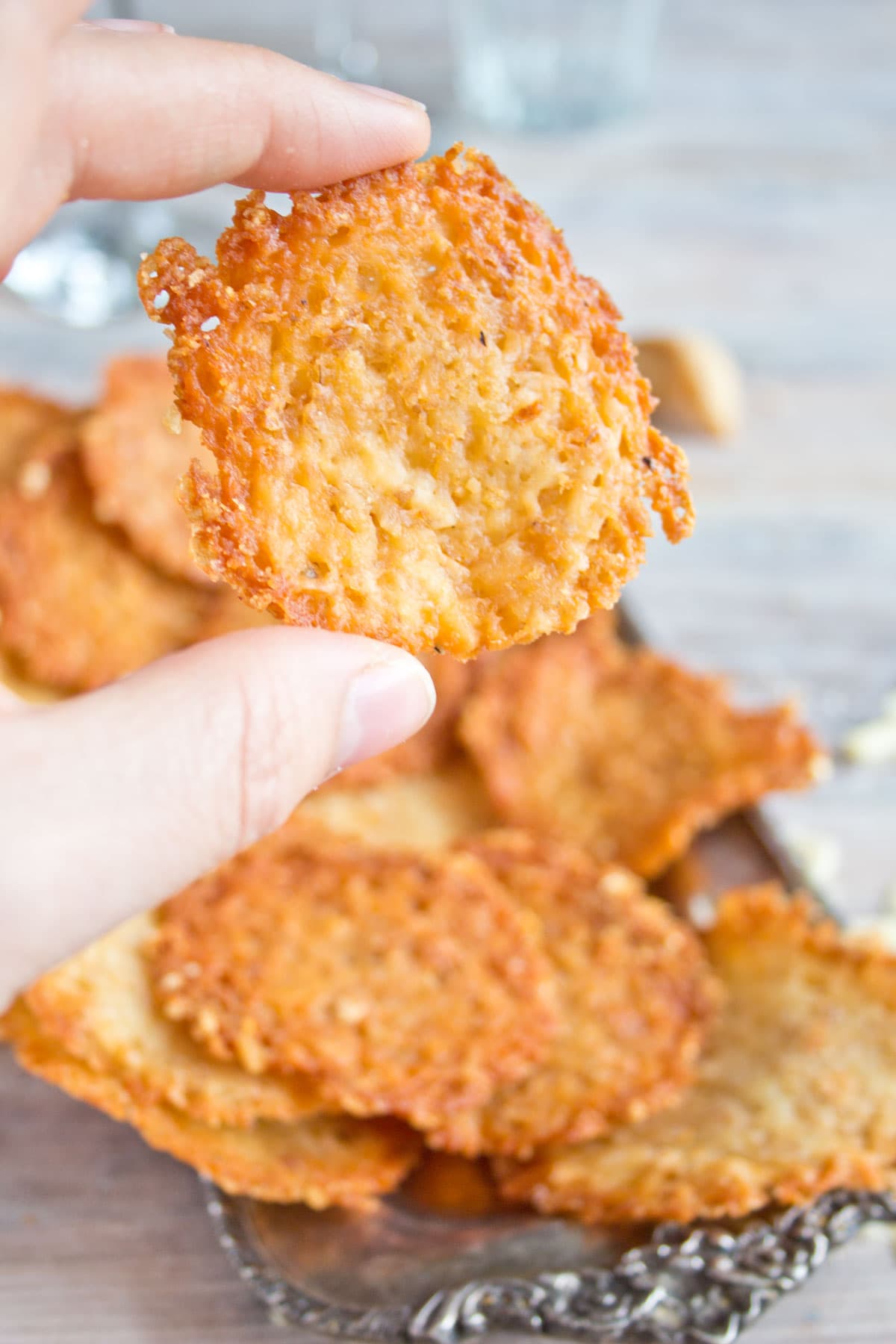 Hand holding a keto cheese chip.