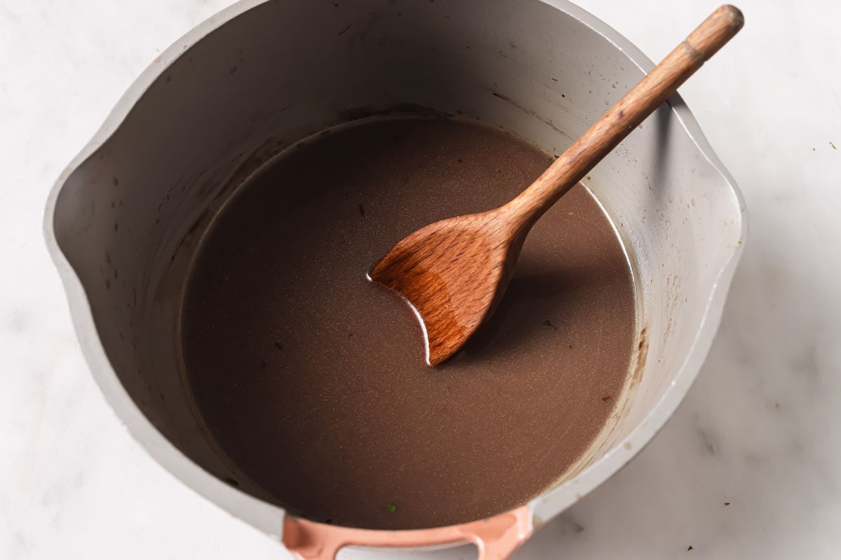 Gray in a pot with a wooden spoon.