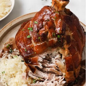 Schweinshaxe on a plate with sauerkraut.