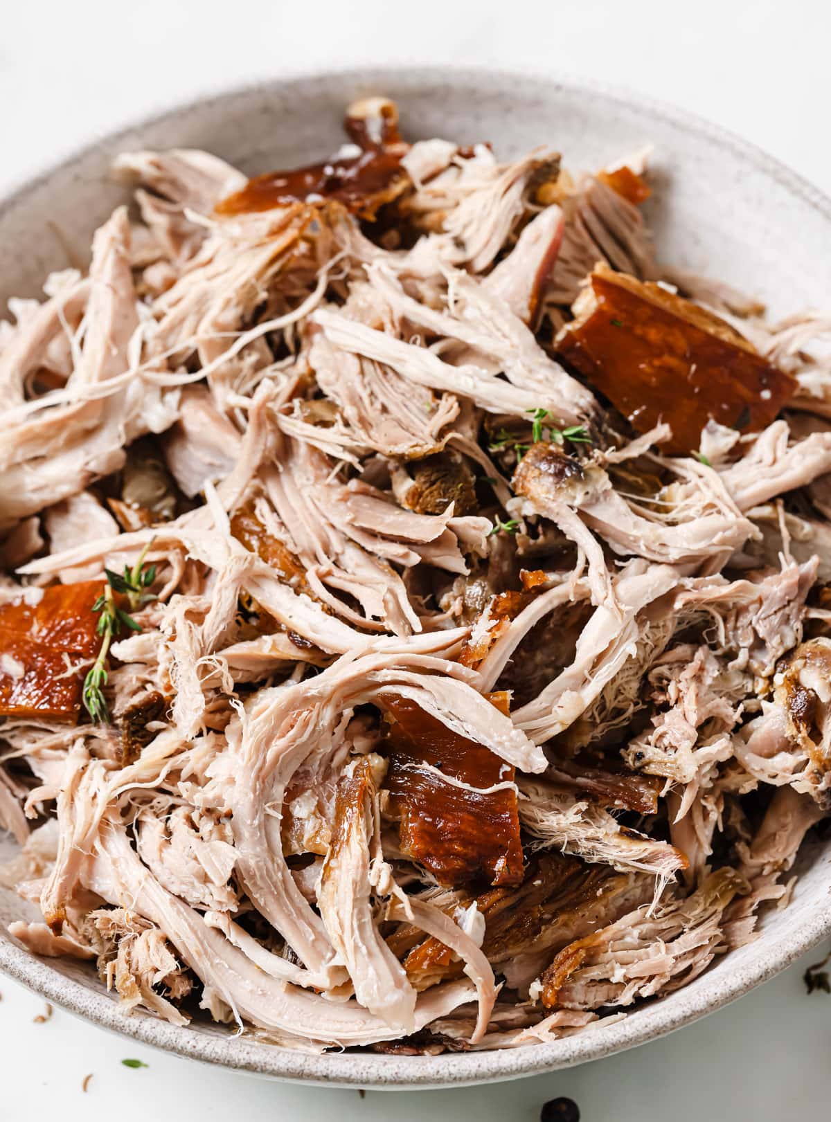 Shredded pork knuckle meat on a plate.