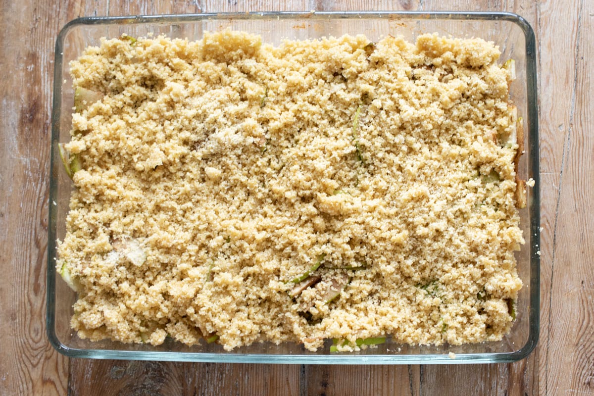 Topping on the apple slices in the baking pan.