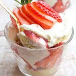 Sugar free trifle with strawberries in a cup and a spoon.