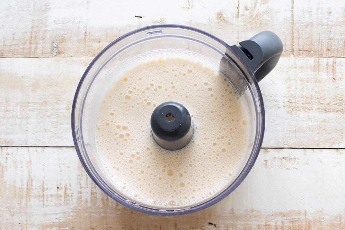 Blended eggs in a food processor bowl.