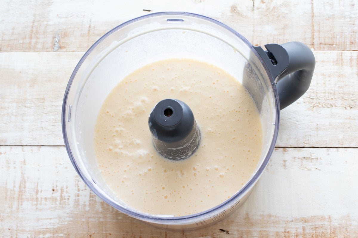 Eggs and all ther wet ingredients blended in a food processor bowl.