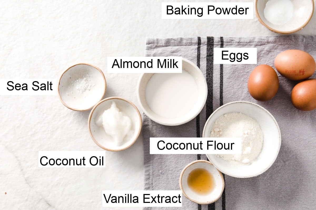 Ingredients to make coconut flour pancakes, measured into bowls and labelled.