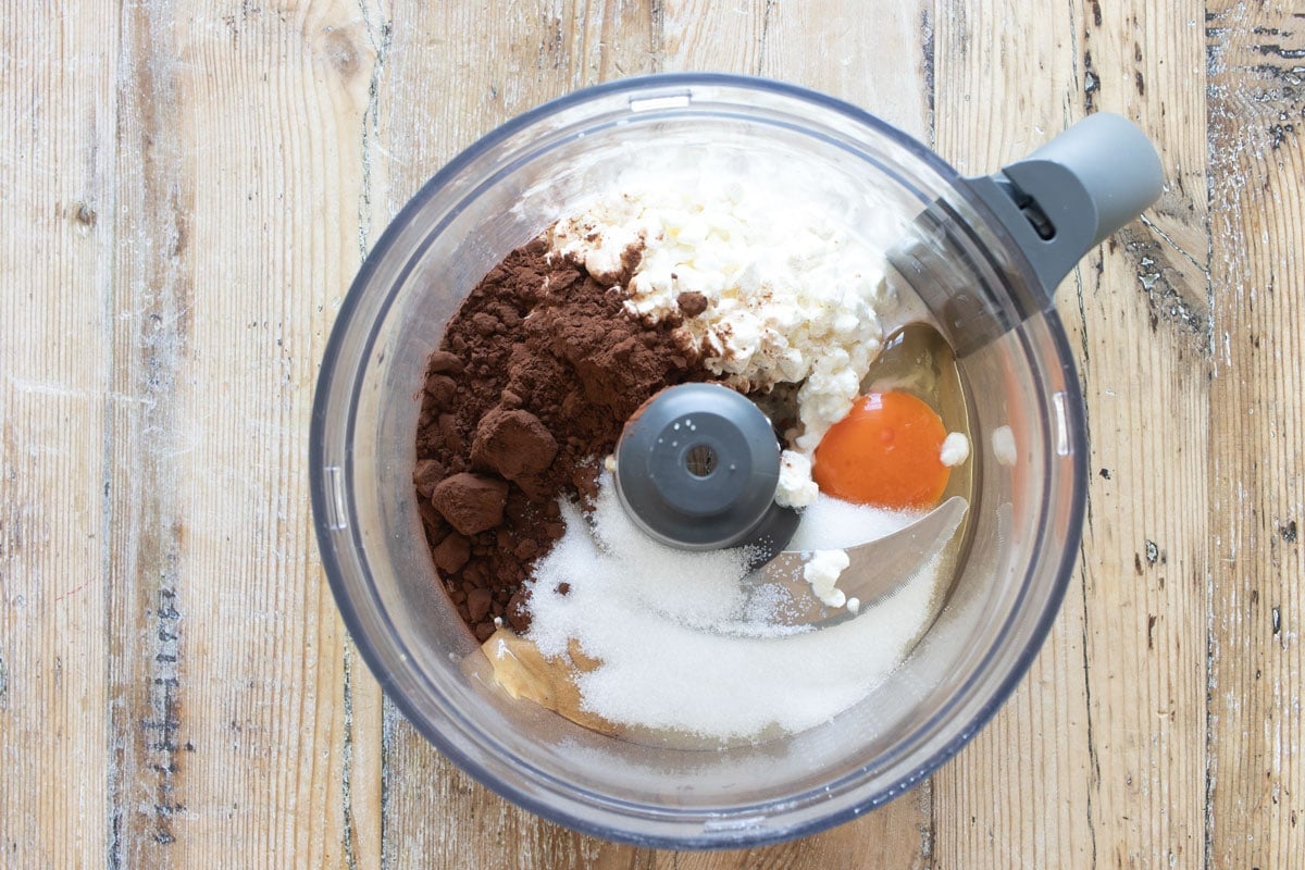 Brownie ingredients in the food processor bowl.