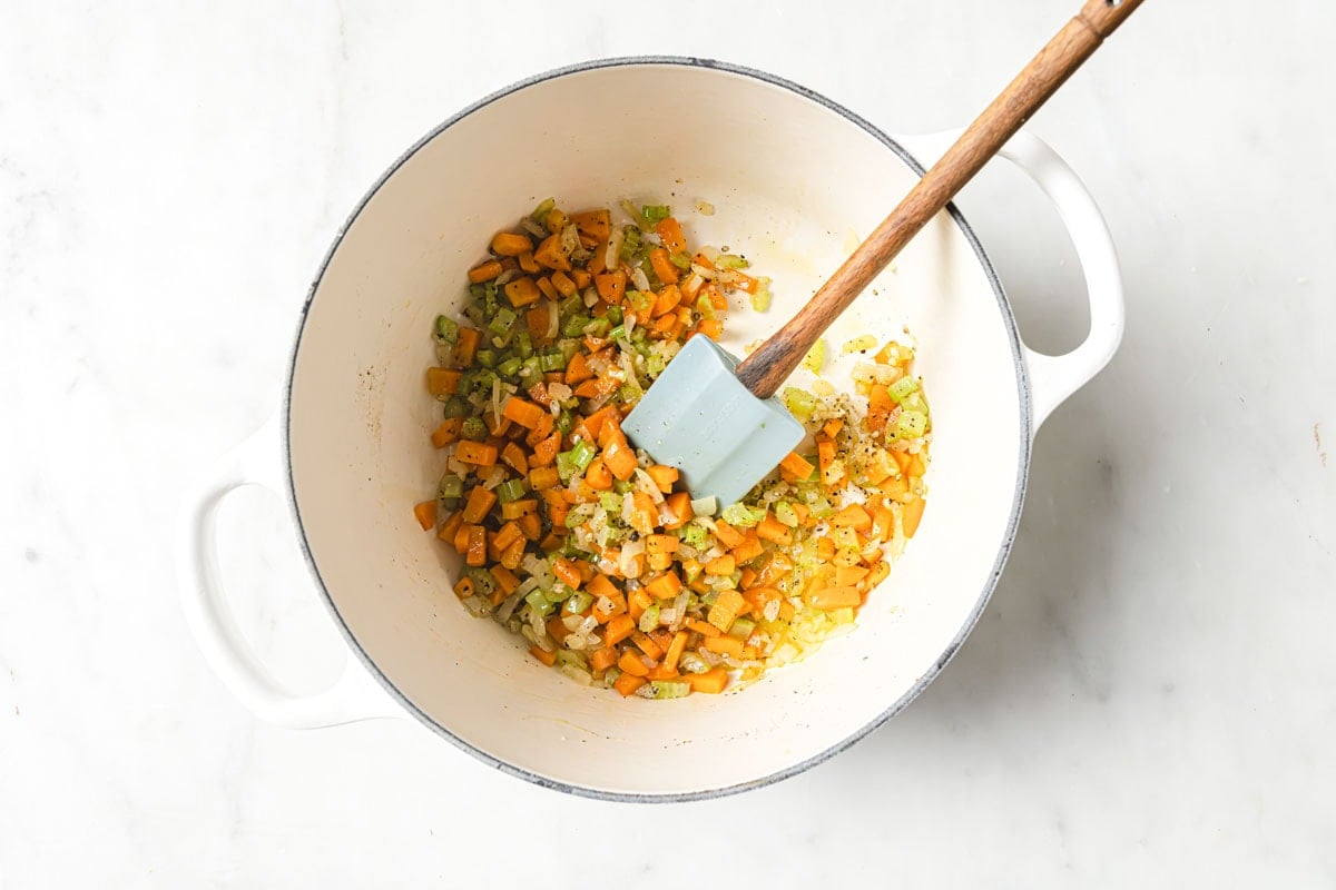 Chopped vegetables, garlic and seasoning in a pot.