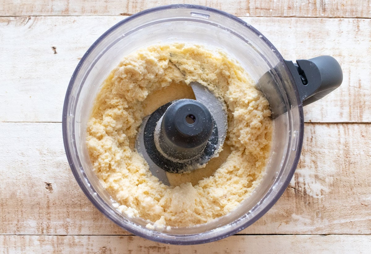 Biscuit batter in a food processor bowl.